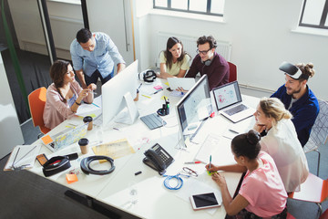 Computer programmers working in open plan office