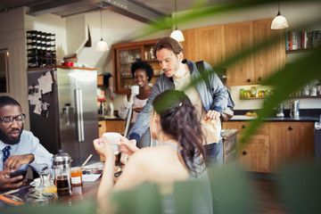 Friend roommates drinking coffee at breakfast table