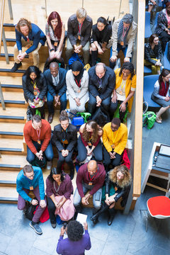 Overhead view conference audience listening to speaker