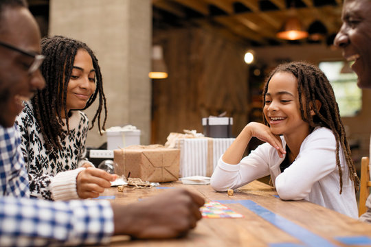 Family playing game at table