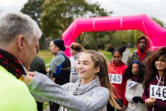 Daughter placing medal around neck of father at charity run