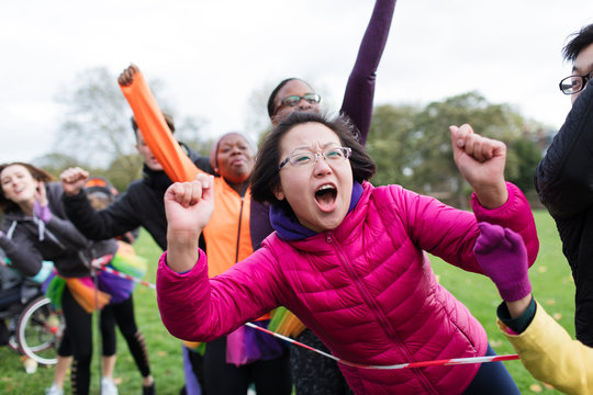 Enthusiastic female spectator cheering at charity run in park