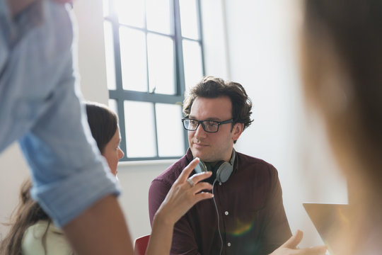 Businessman talking, gesturing in conference room meeting