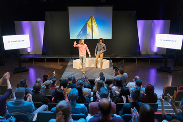 Audience clapping for photographers on stage