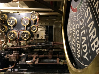 Ancient and historic mechanical control panels with lights and analogue displays in machine room of...