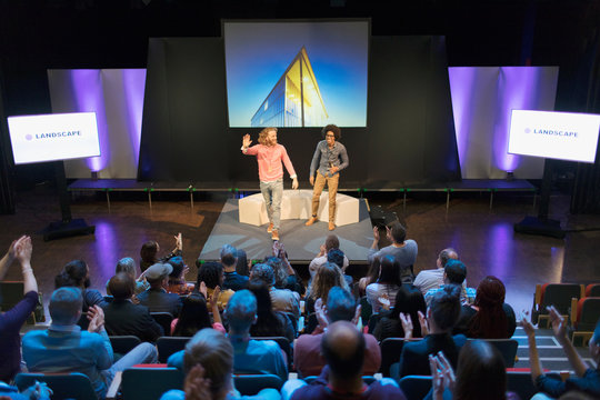 Audience clapping for photographers on stage