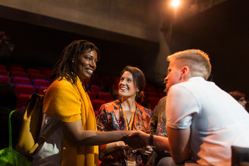 Women handshaking at conference