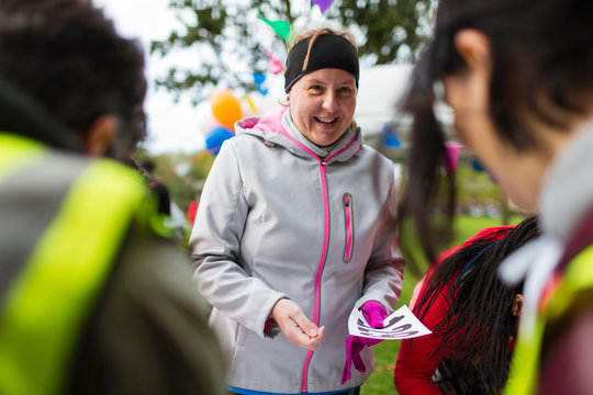 Smiling woman with marathon bib at charity run
