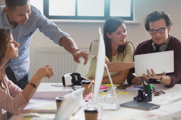 Computer programmers programming virtual reality simulator glasses in office
