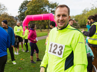 Portrait confident male runner at charity run in park