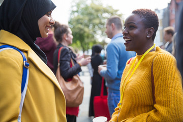 Businesswomen talking at conference
