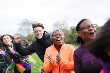 Enthusiastic spectators cheering at charity run in park