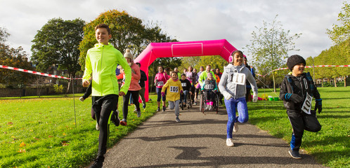 Kids running at charity run in sunny park