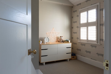 Illuminated string light star on dresser in child‚Äôs bedroom