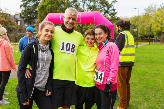 Portrait smiling family runners at charity run in park