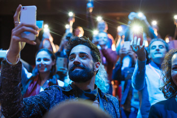 Audience using smart phone flashlights