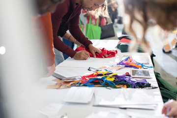 Business people arriving receiving identification card at conference registration table