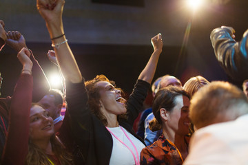 Enthusiastic woman cheering in audience
