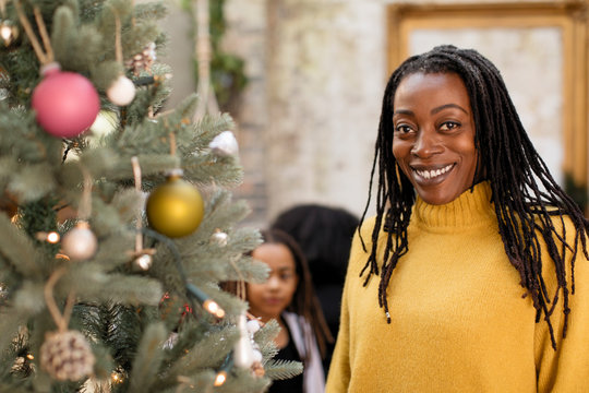 Portrait smiling, confident woman at Christmas tree