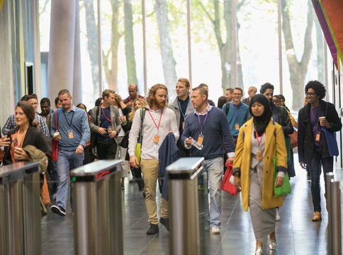 Business People Arriving At Conference, Walking In Lobby