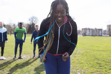 Smiling woman exercising in park