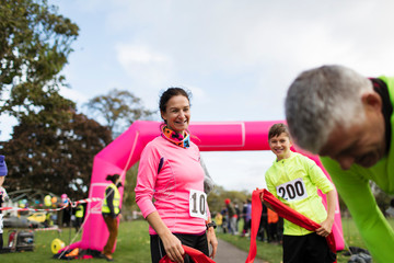Family runners crossing finish line at charity run