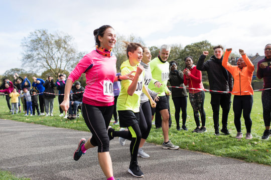 Enthusiastic family runners running in charity run at park