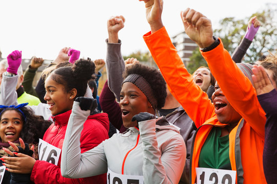 Enthusiastic runners cheering at charity run
