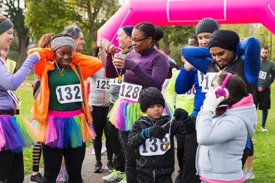 Family And Friends With Medals At Charity Run In Park