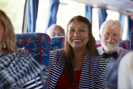 Portrait smiling, confident active senior woman tourist riding tour bus