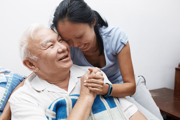 Affectionate, smiling senior father and daughter hugging