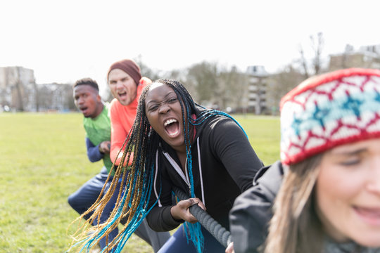 Determined team pulling rope in tug-of-war