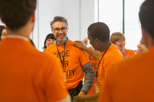 Happy hackers coding for charity at hackathon