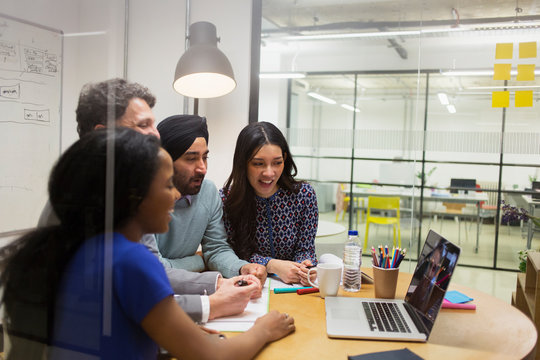 Creative Business People Video Conferencing At Laptop In Conference Room