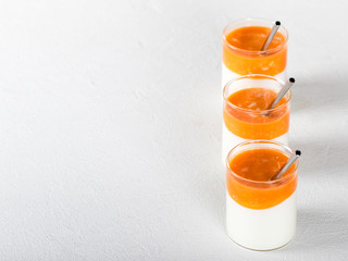 Fermented milk drink with carrot juice and sea buckthorn on a light background