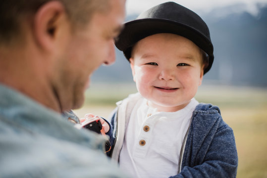Portrait cute baby boy over father s shoulder