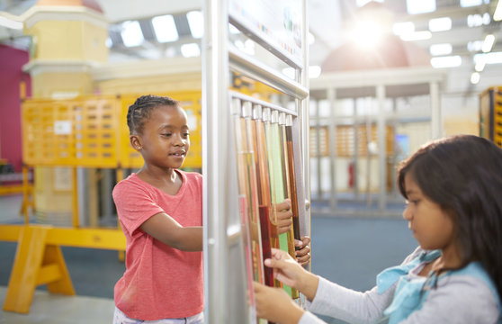 Curious girls at interactive exhibit in science center