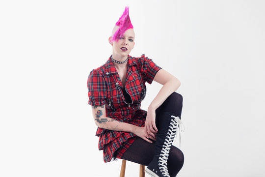 Portrait confident young woman with pink mohawk