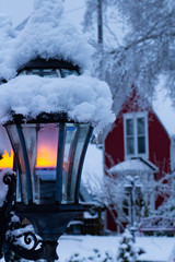 Lantern in Snow with Red House