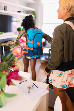 Young women friends arriving at house rental