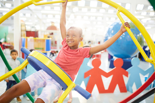 Girl using gyroscope in science center