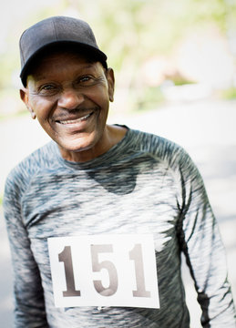 Portrait smiling, confident active senior man wearing sports race bib