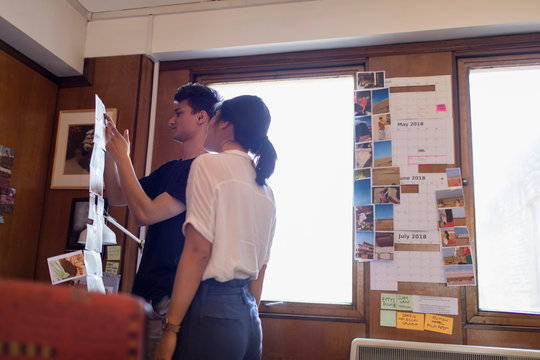 Creative designers reviewing photograph proofs in office