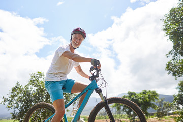 Portrait smiling, confident mature man mountain biking