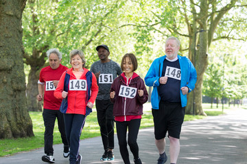 Active seniors power walking sports race in park