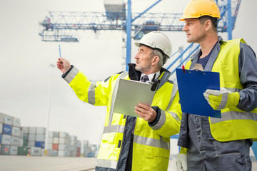 Dock worker and manager talking at shipyard