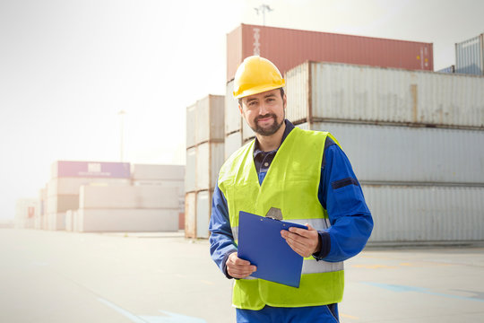 Portrait confident dock worker with clipboard at shipyard