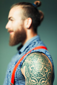 Close Up Hipster Man With Shoulder Tattoo And Beard