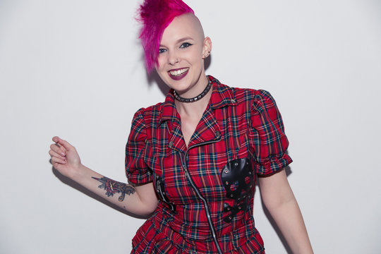 Portrait smiling, confident young woman with pink mohawk