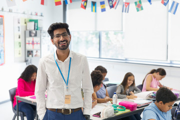 Portrait smiling, confident male teacher in classroom